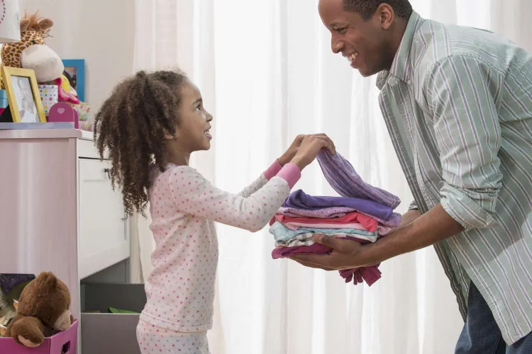 child and father organizing clothes