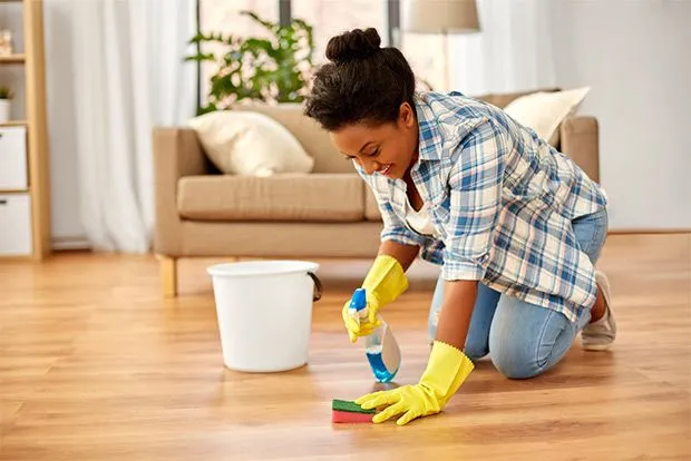 cleaning the floor of a living room