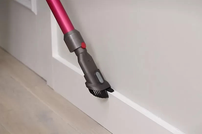 cleaning a baseboard